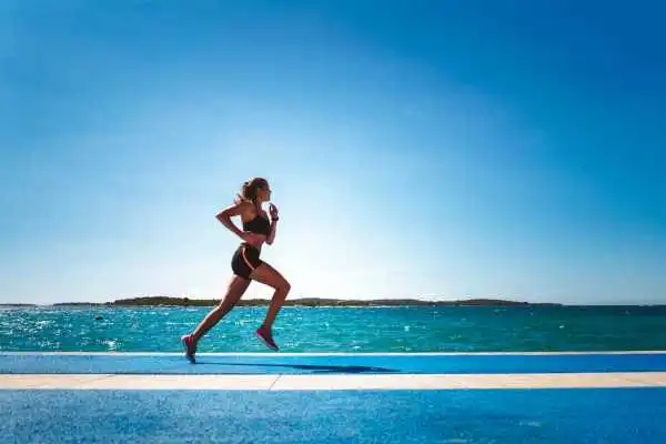 Woman running showing strong leg muscle Winkfield